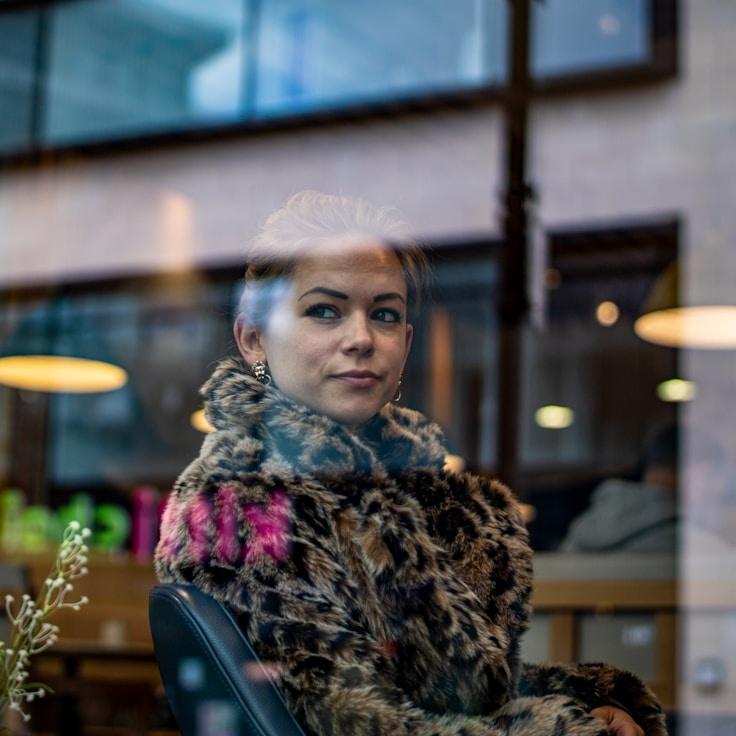 Kaveri Mehta, Lead Design Curator at Open Forest Horizon, reviewing corporate floral arrangements